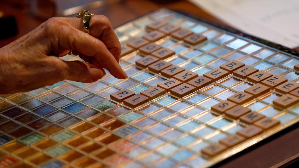 Wilota 'Willie' Swanson places her tiles during a Scrabble game with her close friends Martha Noyes and Gig Ingebretson at Swanson's home, in Sebastopol, California, on Wednesday, April 26, 2017. (Alvin Jornada / The Press Democrat)