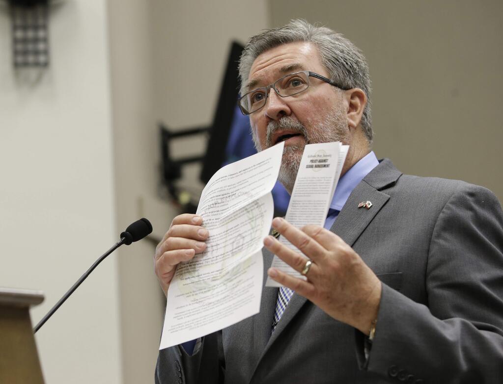 Assemblyman Ken Cooley, D-Rancho Cordova, displays state and legislative policies concerning sexual harassment during a committee hearing tasked with revising the California Assembly's sexual harassment policies, Tuesday, Nov. 28, 2017, in Sacramento, Calif. Cooley, chair of the Assembly rules committee detailed how harassment complaints against members of the Assembly are handled. (AP Photo/Rich Pedroncelli)