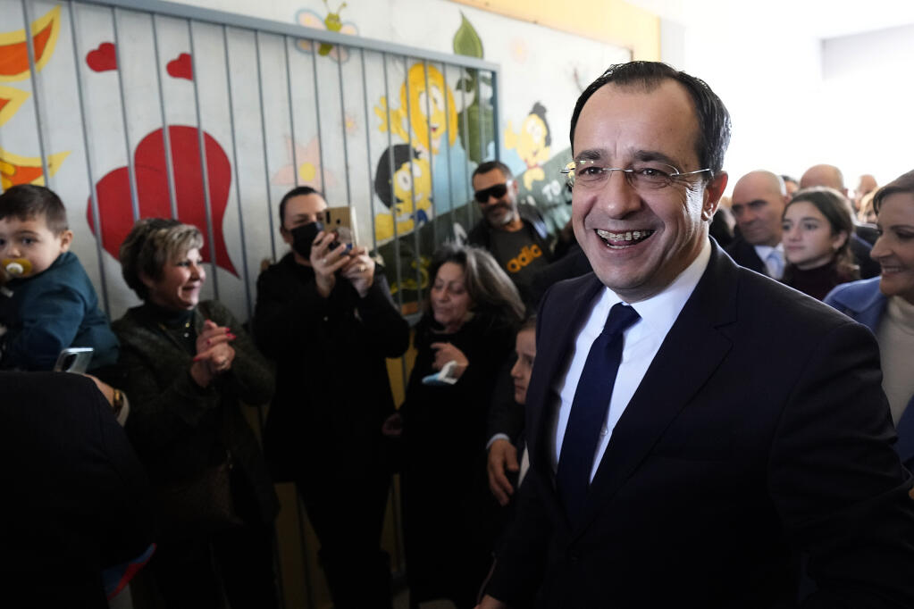 Presidential candidate Nikos Christodoulides smiles as walks with his supporters after casting his vote during the presidential elections in Geroskipou in south west coastal city of Paphos, Cyprus, Sunday, Feb. 12, 2023. Voting has started in a runoff to elect ethnically split Cyprus' eighth new president, pitting a former foreign minister who campaigned as a unifier eschewing ideological and party divisions against a popular veteran diplomat. Some 561,000 citizens are eligible to vote and both Nikos Christoulides, the ex-foreign minister and Andreas Mavroyiannis are hoping for a higher turnout than the 72% that cast ballots in Feb. 5 first round. (AP Photo/Petros Karadjias)