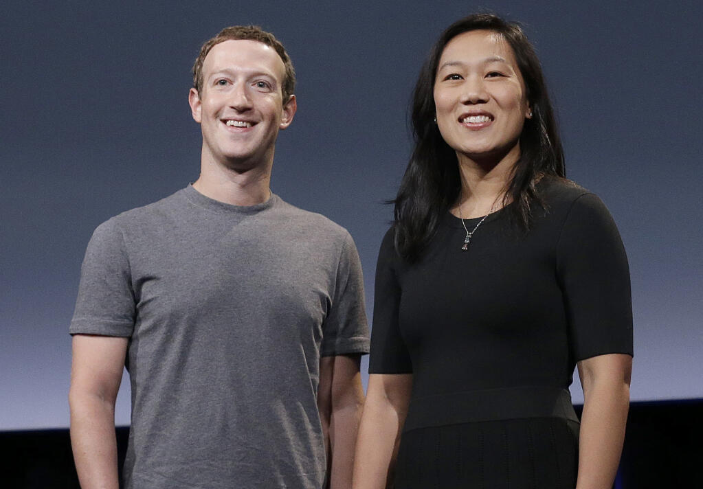 FILE- In this Sept. 20, 2016, file photo, Facebook CEO Mark Zuckerberg and his wife, Priscilla Chan, smile as they prepare for a speech in San Francisco. Facebook founder Mark Zuckerberg and his wife, Priscilla Chan, on Tuesday, Oct. 13, 2020, donated an additional $100 million to helping local election offices prepare for November even as some conservatives are stepping up their efforts to stop the funds from being used. (AP Photo/Jeff Chiu, File)