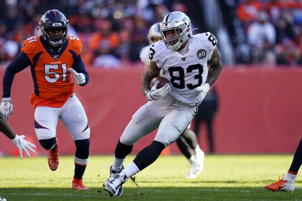 Oakland Raiders tight end Darren Waller (83) runs with the ball as Denver Broncos inside linebacker Todd Davis (51) defends during the first half of an NFL football game Sunday, Dec. 29, 2019, in Denver. (AP Photo/Jack Dempsey)