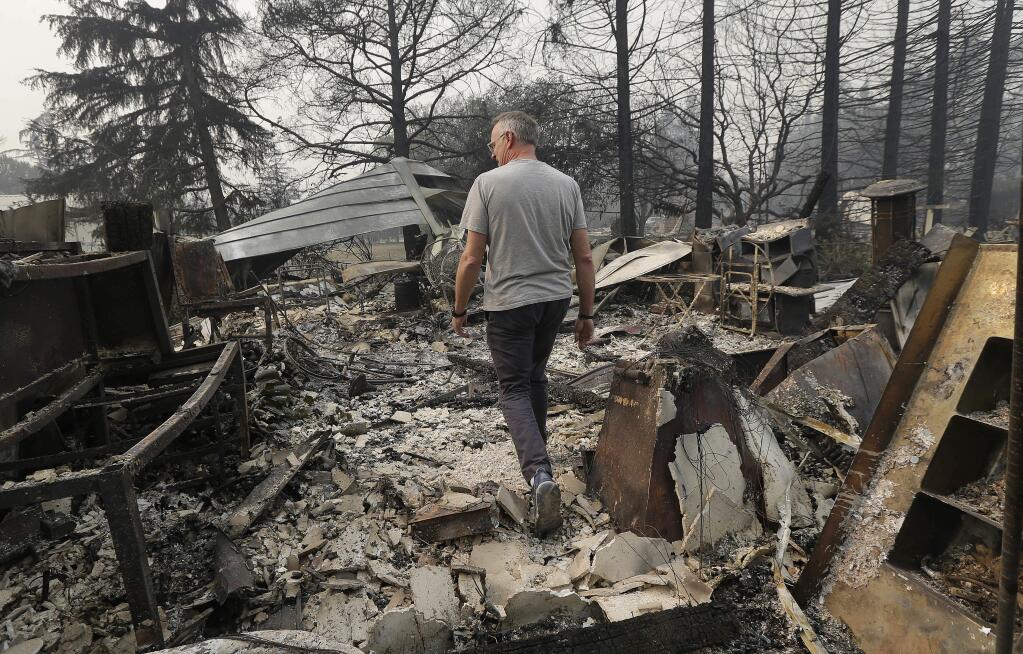 Todd Caughey walks through a wine making room at the site of his family's home destroyed by fires in Kenwood, Calif., Tuesday, Oct. 10, 2017. (AP Photo/Jeff Chiu)