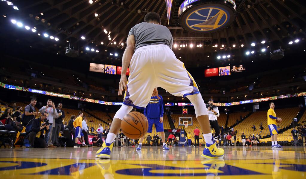 Golden State Warriors guard Stephen Curry warms up before his shoot around prior to Game 1 of the NBA Playoffs Western Conference Finals at Oracle Arena, in Oakland on Tuesday, May 19, 2015. (Christopher Chung/ The Press Democrat)