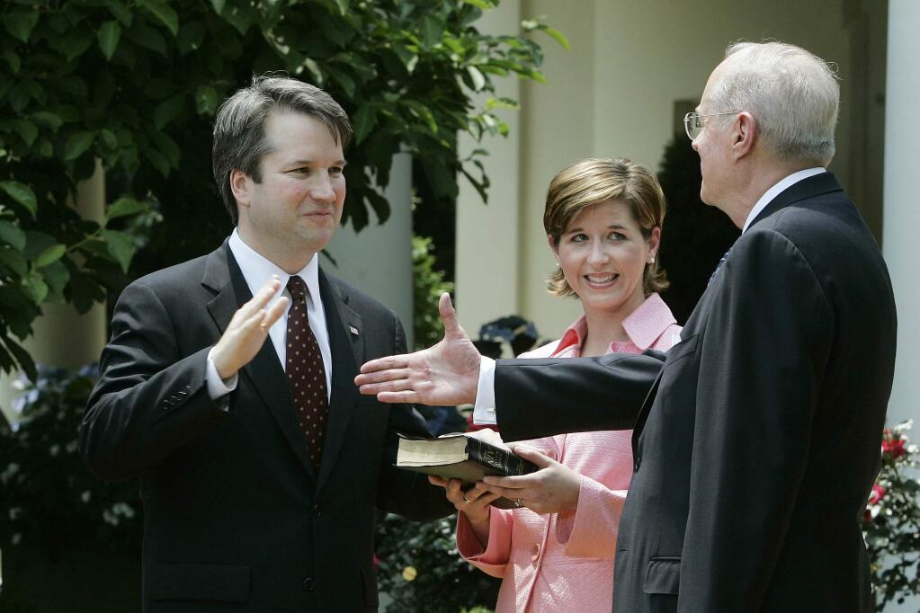 Judge Brett Kavanaugh, who was nominated this week to the U.S. Supreme Corut, is sworn into the U.S. Court of Appeals by Justice Anthony Kennedy in 2006. (DOUG MILLS / New York Times)