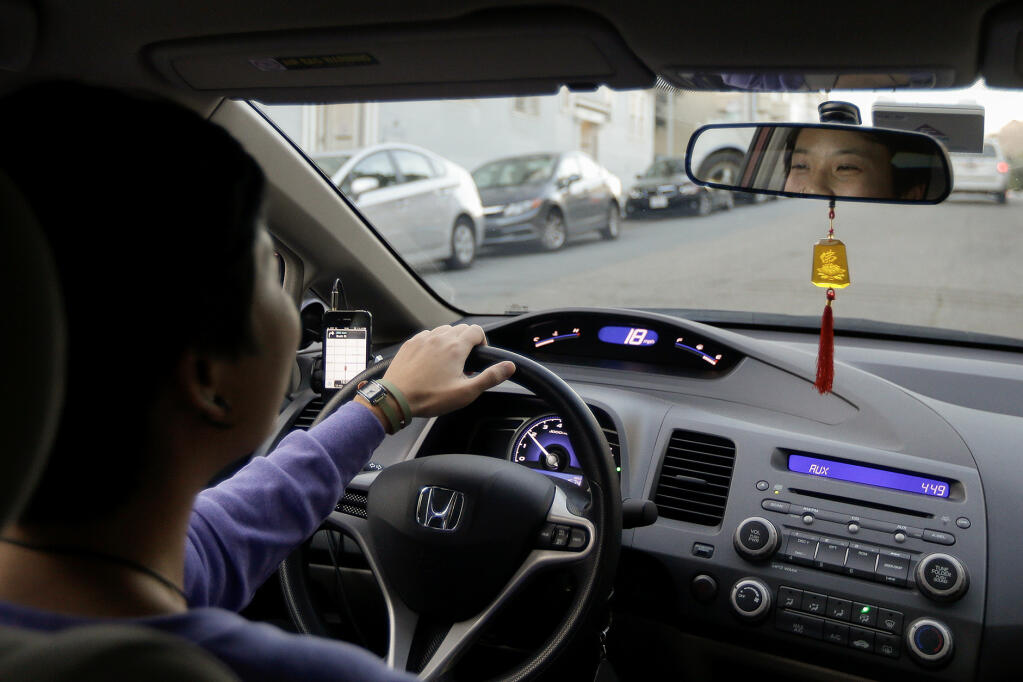 A Lyft driver working in San Francisco in 2013. Photo by Jeff Chiu, AP Photo