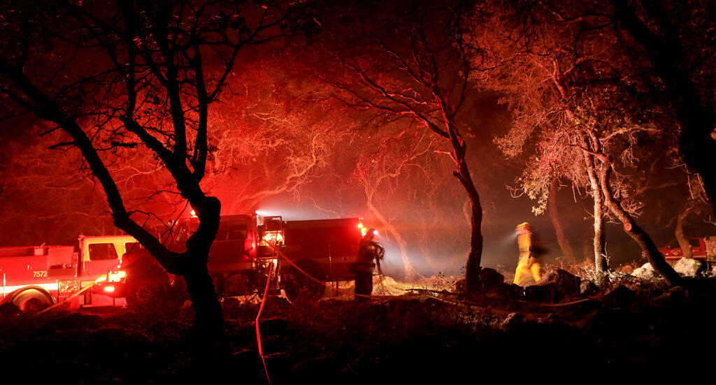 A Rincon Valley responded mutual aid to help fight a vegetation fire above Lake Ralphine in Howarth Park, Thursday, Nov. 8, 2018 in Santa Rosa.  (Kent Porter / The Press Democrat) 2018