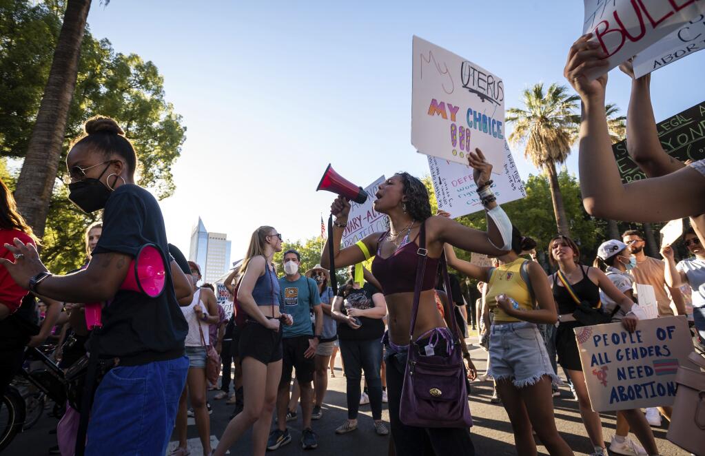 A woman who identified herself as Jada chants into a bullhorn outside the California Capitol during a protest of the U.S. Supreme Court's decision to effectively end Roe v. Wade on Friday, June 24, 2022, in Sacramento, Calif. (Xavier Mascareñas/The Sacramento Bee via AP)