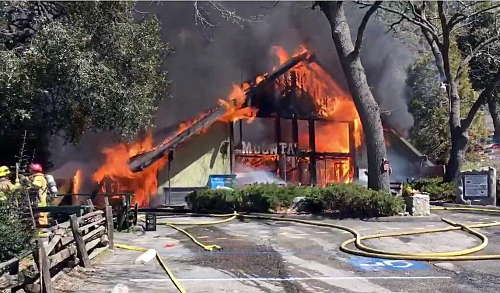 This photo provided by the San Bernardino County Sheriff's Office shows a fire at the Mountain Town Reptile Museum in Oak Glen, Calif., Thursday, March 14, 2019. Authorities say small animals including turtles, snakes and parakeets are feared dead. Jenny Smith with the San Bernardino County Sheriff's Department says that firefighters were able to rescue some macaws and African grey parrots. Crews responding shortly before noon found heavy smoke and flames.. Animals in pens outside, including goats, deer and geese, were unharmed. (San Bernardino County Sheriff's Office via AP)