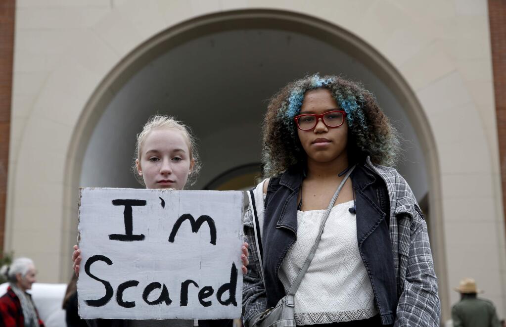 Sophie Warner, 14, left, and Angelique Lindberg, 14, attend the Sonoma County Stands Together for Women rally to demonstrate against President Donald Trump in Santa Rosa, on Saturday, January 21, 2017. (BETH SCHLANKER/ The Press Democrat)