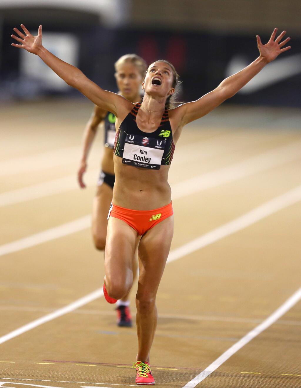 Kim Conley throws her arms up in celebration as she wins the 10,000-meter race at the USA Track and Field Outdoor Championships in Sacramento on Thursday, June 26, 2014. (Christopher Chung / The Press Democrat)