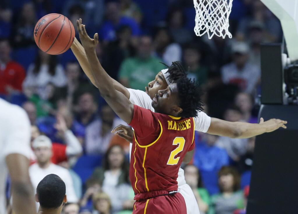 USC guard Jonah Mathews (2) reaches for a rebound with Southern Methodist forward Ben Moore, rear, in the first half of a first-round game in the NCAA tournament in Tulsa, Okla., Friday, March 17, 2017. (AP Photo/Sue Ogrocki)