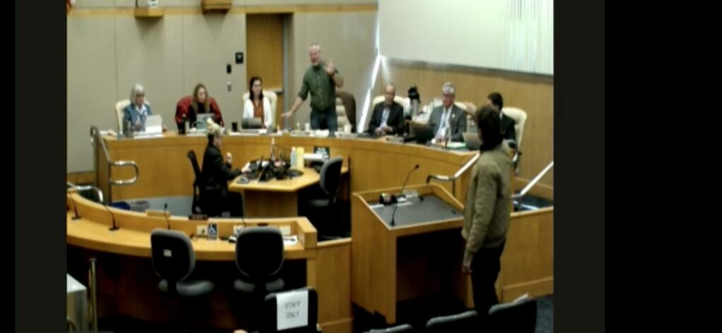 Santa Rosa resident Shelby Pryor (standing at podium) confronts Chairperson James Gore at the April 19, 2022, meeting of the Sonoma County Board of Supervisors.