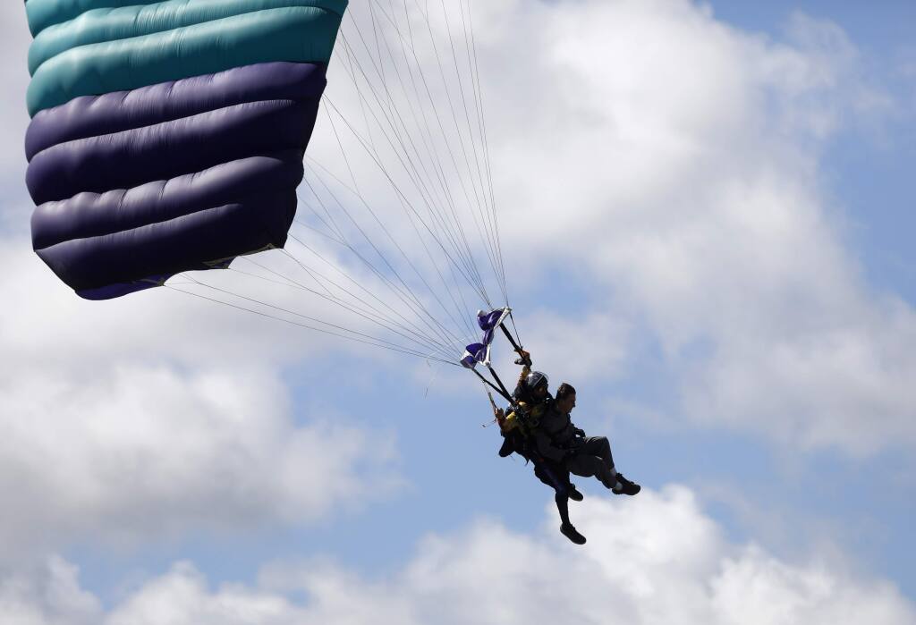 Max Psaledakis, a firefighter with Sonoma Valley Fire and Rescue Authority, skydives with tandem instructor Brad Patterson during a First Responders Appreciation Day hosted by Skydive Golden Gate at the Gnoss Field/Marin County Airport on Sunday, March 25, 2018 in Novato, California . (BETH SCHLANKER/The Press Democrat)