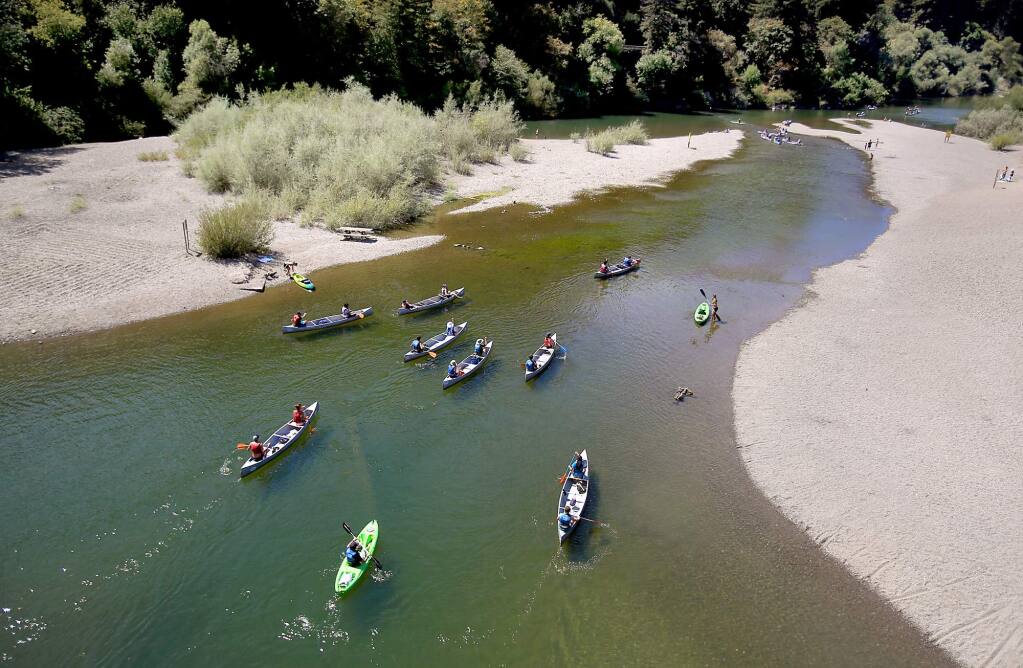 On a pleasant late summer day, canoes are paddled from the Monte Rio beach, Thursday Aug. 27, 2015 on the Russian River. (Kent Porter / Press Democrat) 2015