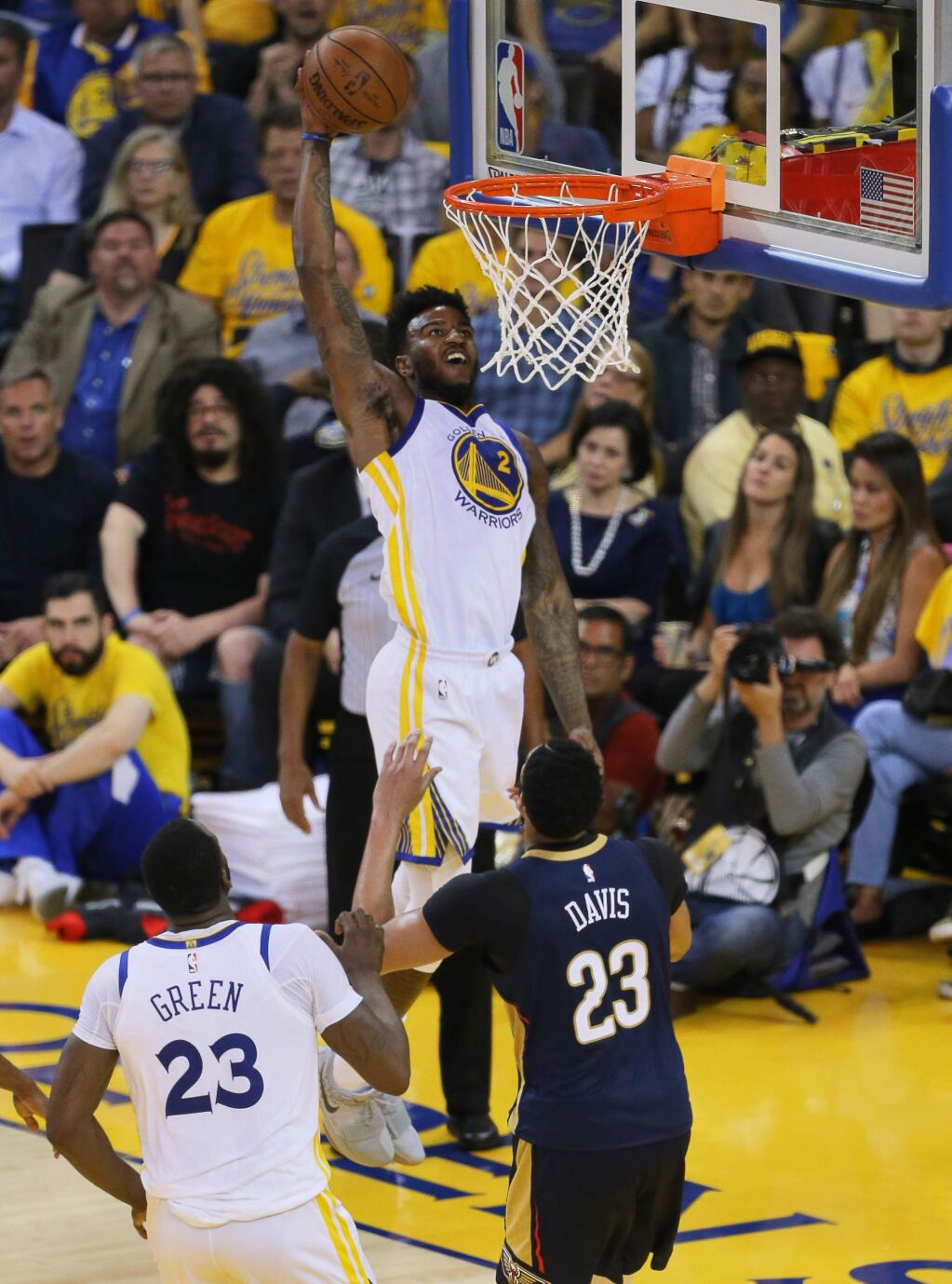 Golden State Warriors center Jordan Bell goes up for a dunk over New Orleans Pelicans center Anthony Davis, during their game in Oakland on Tuesday, May 8, 2018. (Christopher Chung / The Press Democrat)