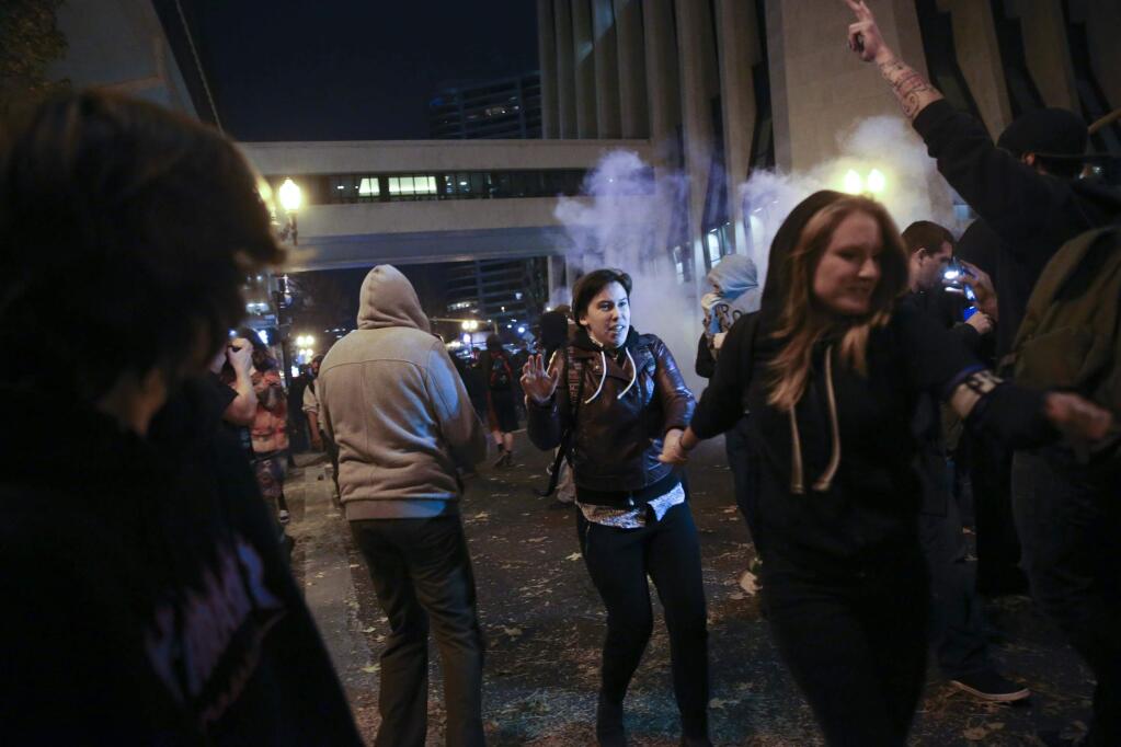Police in downtown Portland, Ore., attempt to disperse people protesting the election of Donald Trump. (STEPHANIE YAO LONG / Oregonian)