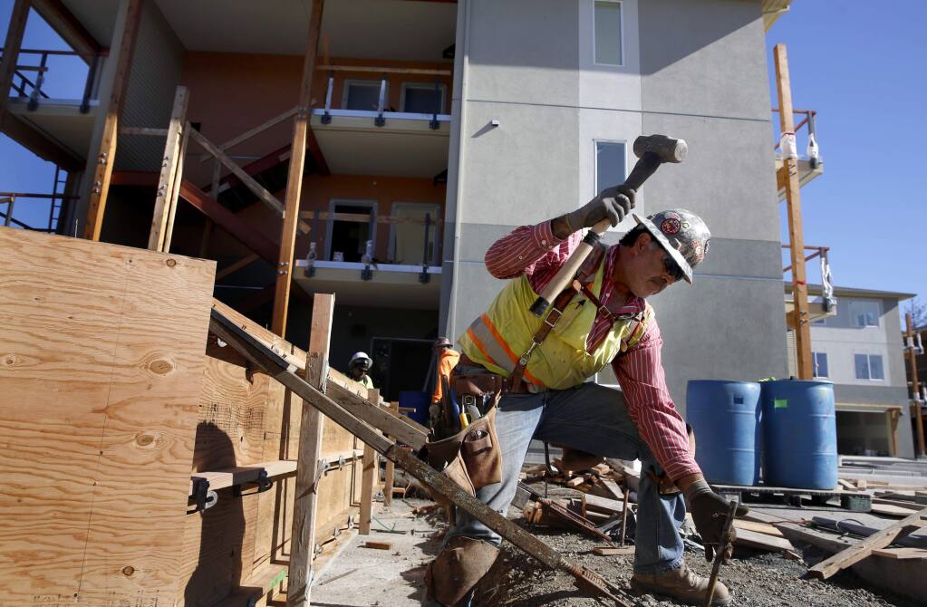 (FILE PHOTO) Salvador Preciado of R.E. Maher Inc. builds a wooden frame for a concrete wall to be poured amid work on the Fetters Apartment complex outside of Sonoma on Wednesday, November 16, 2016. Sonoma County officials are working to fast track higher density housing options outside cities. (BETH SCHLANKER/ The Press Democrat)