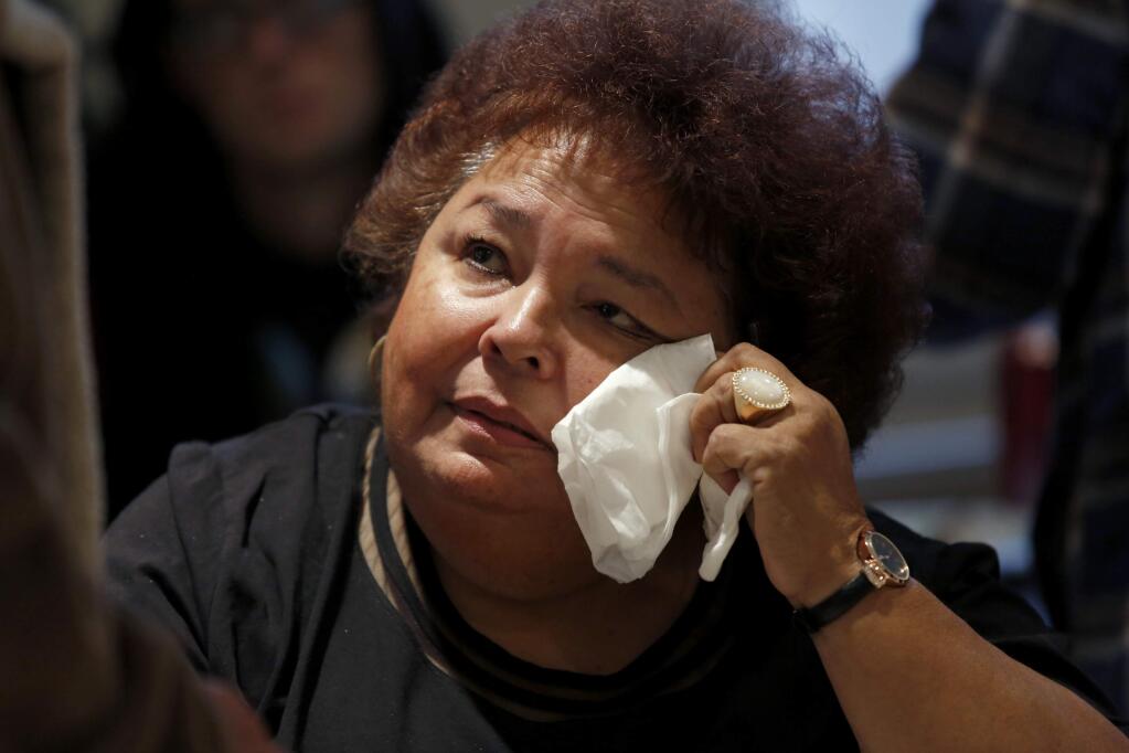 Delores Leon, the niece of Sam Garcia, reacts while talking to boat wreck survivor, Phil Sanchez, during a memorial celebration for fishermen Sam Garcia and Jesse Langley at the Porto Bodega clubhouse on Sunday, December 7, 2014 in Bodega Bay, California . (BETH SCHLANKER/ The Press Democrat)