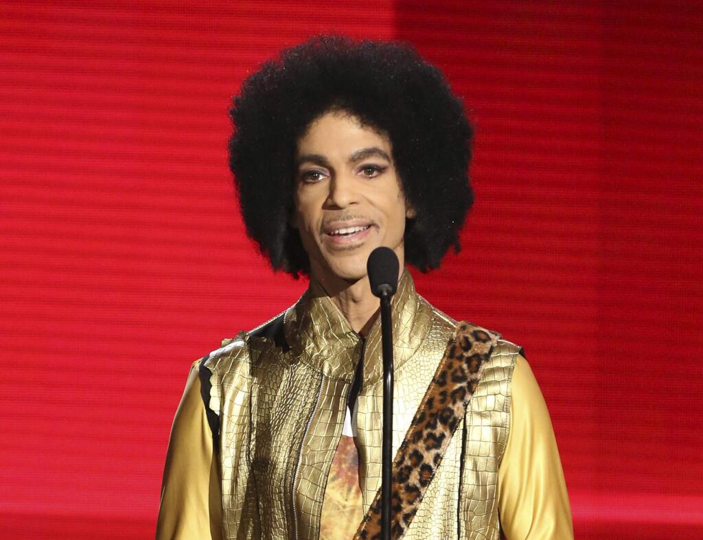 FILE - In this Nov. 22, 2015, file photo, Prince presents the award for favorite album - soul/R&B at the American Music Awards in Los Angeles. Prince died at his home in Chanhassen, Minn. on April 21, 2016 at the age of 57. (Photo by Matt Sayles/Invision/AP, File)