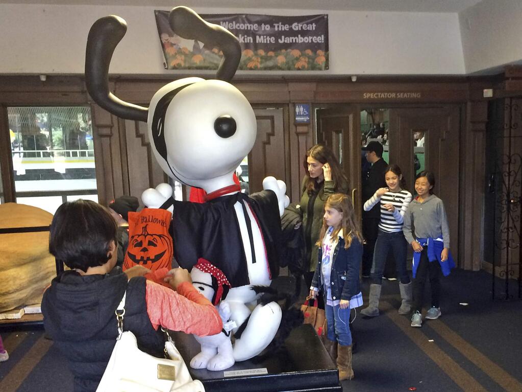 A statue of Snoopy greats hockey families to Snoopy's Home Ice in Santa Rosa, Calif., Sunday, Oct. 22, 2017. The annual hockey tournament for 7- and 8-year-olds was held as scheduled Sunday in the rink financed by Peanuts creator Charles Schultz, a Santa Rosa native and hockey fan. (AP Photo/Paul Elias)