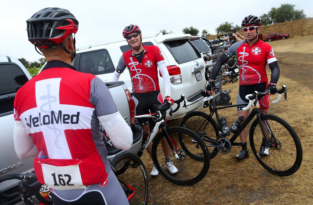 Santa Rosa anesthesiologist and VeloMed founder Dr. David Robertson, center, talks with Dr. Steve Meffert, right, and Dr. Dave Giannetto before the start of the Tour de Fox bike race on Saturday, August 29, 2015. (JOHN BURGESS / The Press Democrat)