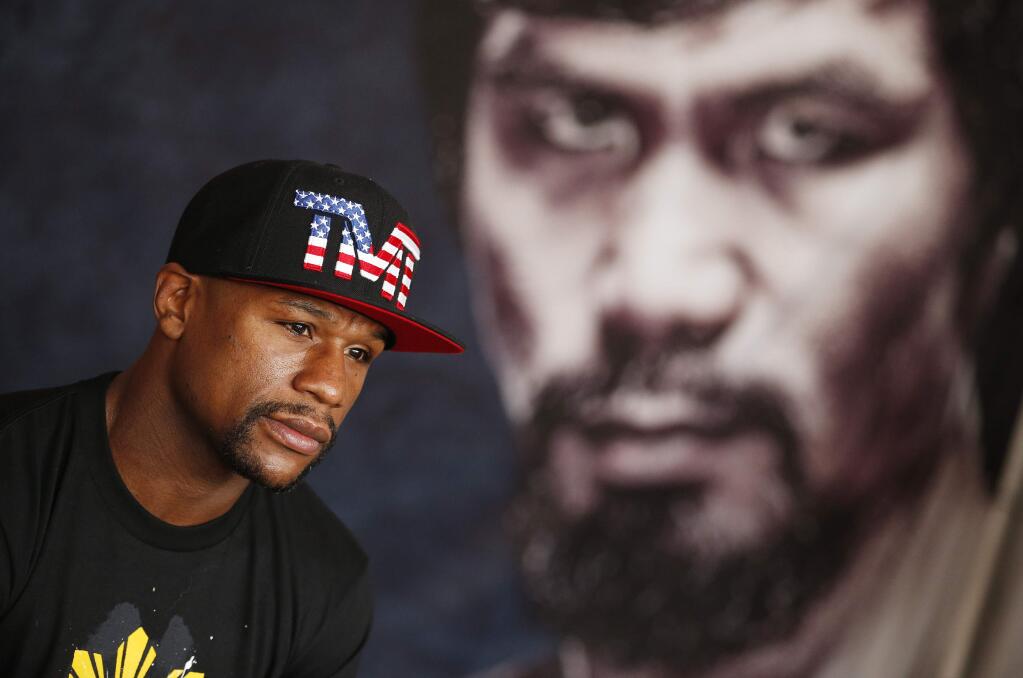 Floyd Mayweather Jr. speaks with the media before a workout Tuesday, April 14, 2015, in Las Vegas. Mayweather is scheduled to fight Manny Pacquiao in a welterweight boxing match in Las Vegas on May 2. (AP Photo/John Locher)