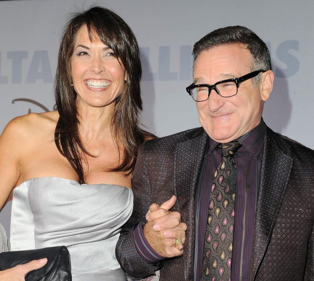 Robin Williams, right, and his wife Susan Schneider at the premiere of 'Old Dogs' in Los Angeles. Williams, whose free-form comedy and adept impressions dazzled audiences for decades, died Monday, Aug. 11, 2014, in an apparent suicide. Williams was 63. (AP Photo/Katy Winn, File 2009)