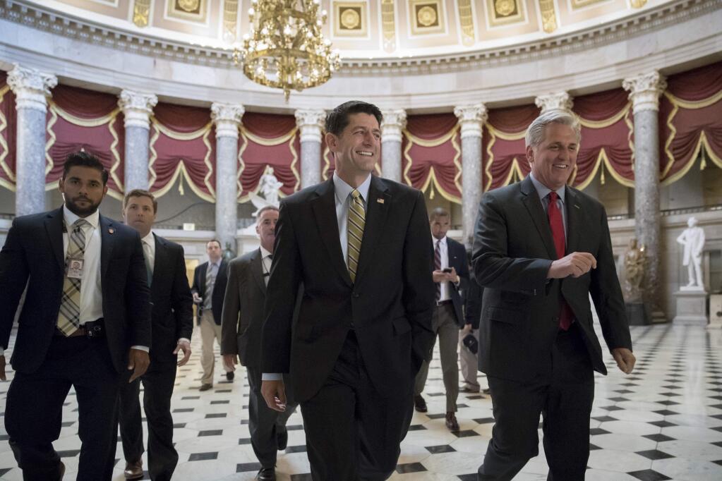 Speaker of the House Paul Ryan, R-Wis., center, and Majority Leader Kevin McCarthy, R-Calif., right, walk to the chamber where the House voted overwhelmingly to send a $15.3 billion disaster aid package to President Donald Trump, overcoming conservative objections to linking the emergency legislation to a temporary increase in America's borrowing authority, at the Capitol in Washington, Friday, Sept. 8, 2017. (AP Photo/J. Scott Applewhite)