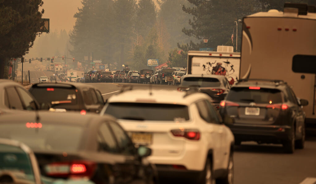 Motorists head out of town on U.S. Highway 50 as they evacuate from South Lake Tahoe due to the Caldor fire, Monday, Aug. 30, 2021. (Kent Porter / The Press Democrat)