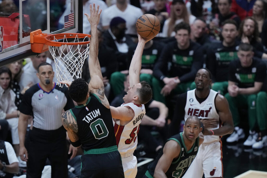 Boston Celtics forward Jayson Tatum (0) defends Miami Heat forward Duncan Robinson (55) during the first half of Game 3 of the NBA basketball playoffs Eastern Conference finals, Sunday, May 21, 2023, in Miami. (AP Photo/Wilfredo Lee)
