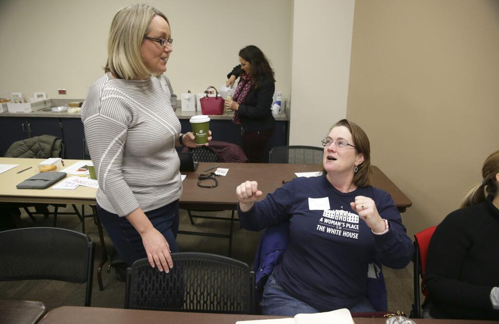 In this Saturday, Dec. 9, 2017 photo, EMILY's List president Stephanie Schriock, left, visits with Amy Hunt before a women's candidate training workshop at El Centro College in Dallas. EMILY'S List, an organization dedicated to electing candidates at all levels of government who support abortion rights, is conducting a national recruitment effort looking to train candidates and potential candidates in over 20 states. (AP Photo/LM Otero)