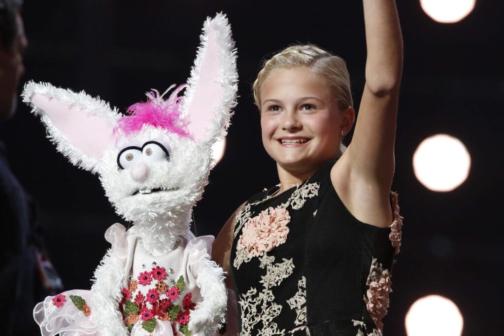This Wednesday, Sept. 20, 2017 photo shows Darci Lynne Farmer on 'America's Got Talent' in Los Angeles. The 12-year-old girl is getting a $1 million prize and her own Las Vegas show after taking the ‚ÄúAmerica‚Äôs Got Talent‚Äù crown on the season 12 finale of the NBC reality competition Wednesday. (Trae Patton/NBC via AP)