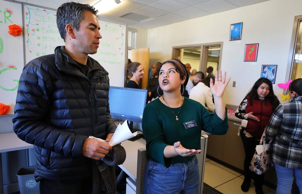 Karla Rubio, right, an SRJC outreach ambassador and Dream Center employee, talks with Juan Arias, director of the college's Hispanic Serving Institution, during the grand reopening of the campus' Dream Center, in Santa Rosa on Thursday, February 21, 2019. (Christopher Chung/ The Press Democrat)