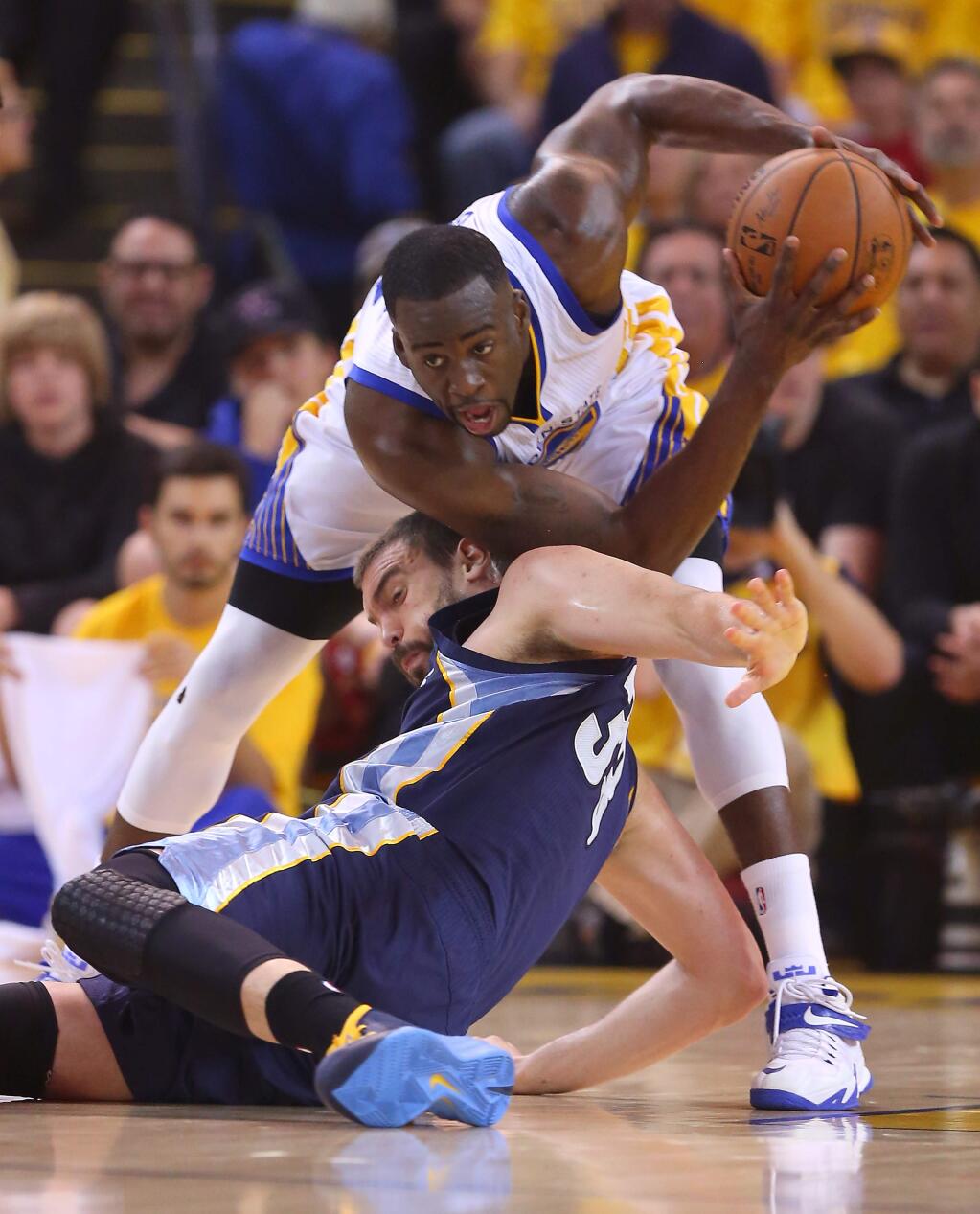 Golden State Warriors forward Draymond Green grabs a loose ball away from Memphis Grizzlies center Marc Gasol during Game 1 of the NBA Playoffs Western Conference Semifinals at Oracle Arena, in Oakland on Sunday, May 3, 2015. (Christopher Chung/ The Press Democrat)