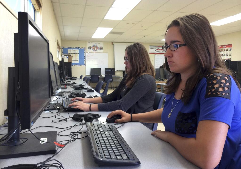 In this April 30, 2015 photo, Leticia Fonseca, 16, left, and her twin sister, Sylvia Fonseca, right, work in the computer lab at Cuyama Valley High School after taking the new Common Core-aligned standardized tests, in New Cuyama, Calif. While the Common Core education standards provoked political backlash and testing boycotts around the country this year, California, the state that educates more public school children than any other, was conspicuously absent from the debate. Gov. Jerry Brown and Californias elected K-12 schools chief are united in their support of the embattled benchmarks. The heads of the states teachers unions, universities and business groups are on board, too. More than one-quarter of the 12 million students who were supposed to take new online tests linked to the standards this spring were Californians, but the technical glitches and parent-led opt-out campaigns that roiled the exams rollout elsewhere did not surface widely here. (AP Photo/Christine Armario)