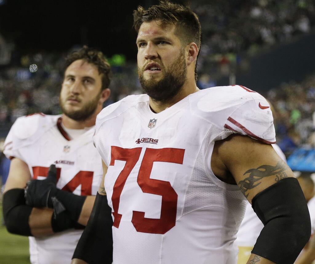 San Francisco 49ers' Alex Boone (75) and Joe Staley watch the field after the NFL football NFC Championship game against the Seattle Seahawks, Sunday, Jan. 19, 2014, in Seattle. The Seahawks won 23-17 to advance to Super Bowl XLVIII. (AP Photo/Marcio Jose Sanchez)