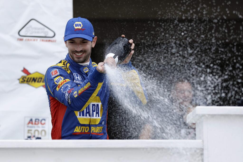 Alexander Rossi celebrates in Victory Lane after winning the IndyCar race at Pocono Raceway, Sunday, Aug. 19, 2018, in Long Pond, Pa. (AP Photo/Matt Slocum)