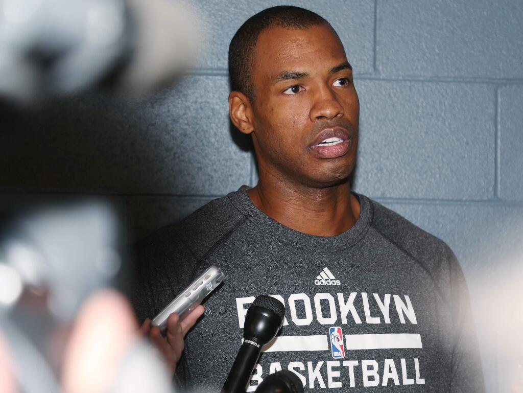 In this Feb. 27, 2014, file photo, Brooklyn Nets center Jason Collins considers a question from reporter before the Nets' NBA basketball game against the Denver Nuggets in Denver. Collins, the NBA's first openly gay player, announced his retirement on Wednesday, Nov. 19, 2014. (AP Photo/David Zalubowski, File)