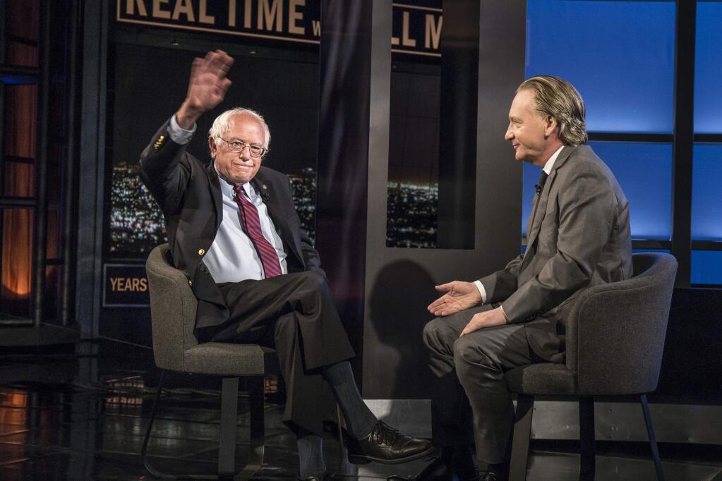 In this photo provided by HBO, Democratic presidential candidate Sen. Bernie Sanders, left, speaks with host Bill Maher during an interview on the television show, 'Real Time With Bill Maher,' Friday, May 27, 2016, in Los Angeles. (Janet Van Ham/HBO via AP)