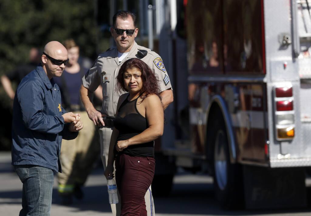 Alejandra Hernandez-Ruiz talks with CHP officers after her two daughters, 7 and 9, drowned when her car crashed into the Petaluma River on Petaluma Boulevard North near Gossage Avenue, Aug. 31, 2016 in Petaluma, California. (BETH SCHLANKER/ The Press Democrat)