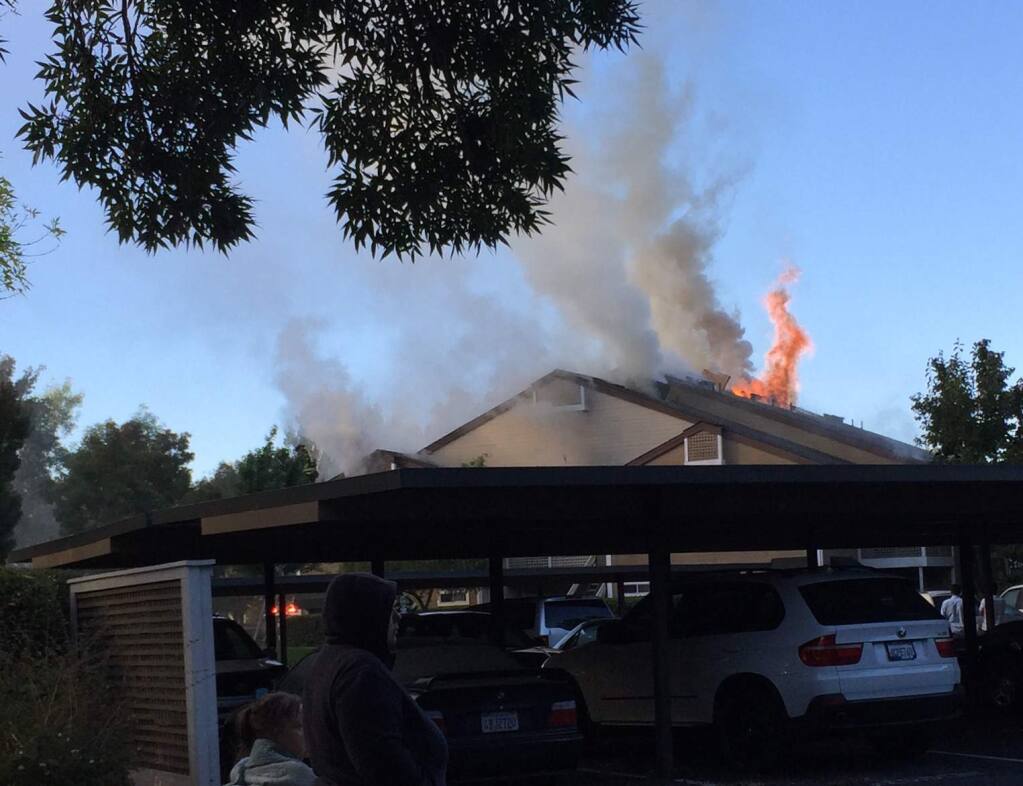Fire burns at The Village apartments on Bay Village Circle in Santa Rosa on Sunday, Oct. 11, 2015. (KARA MADDY)