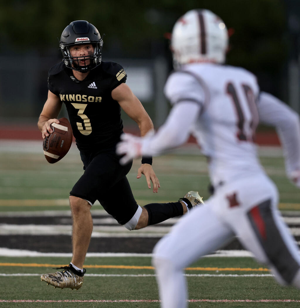 Windsor quarterback Chase Vehmeyer, shown in a game against Montgomery, leads his team in a showdown game against Cardinal Newman Friday night. (Kent Porter / The Press Democrat)
