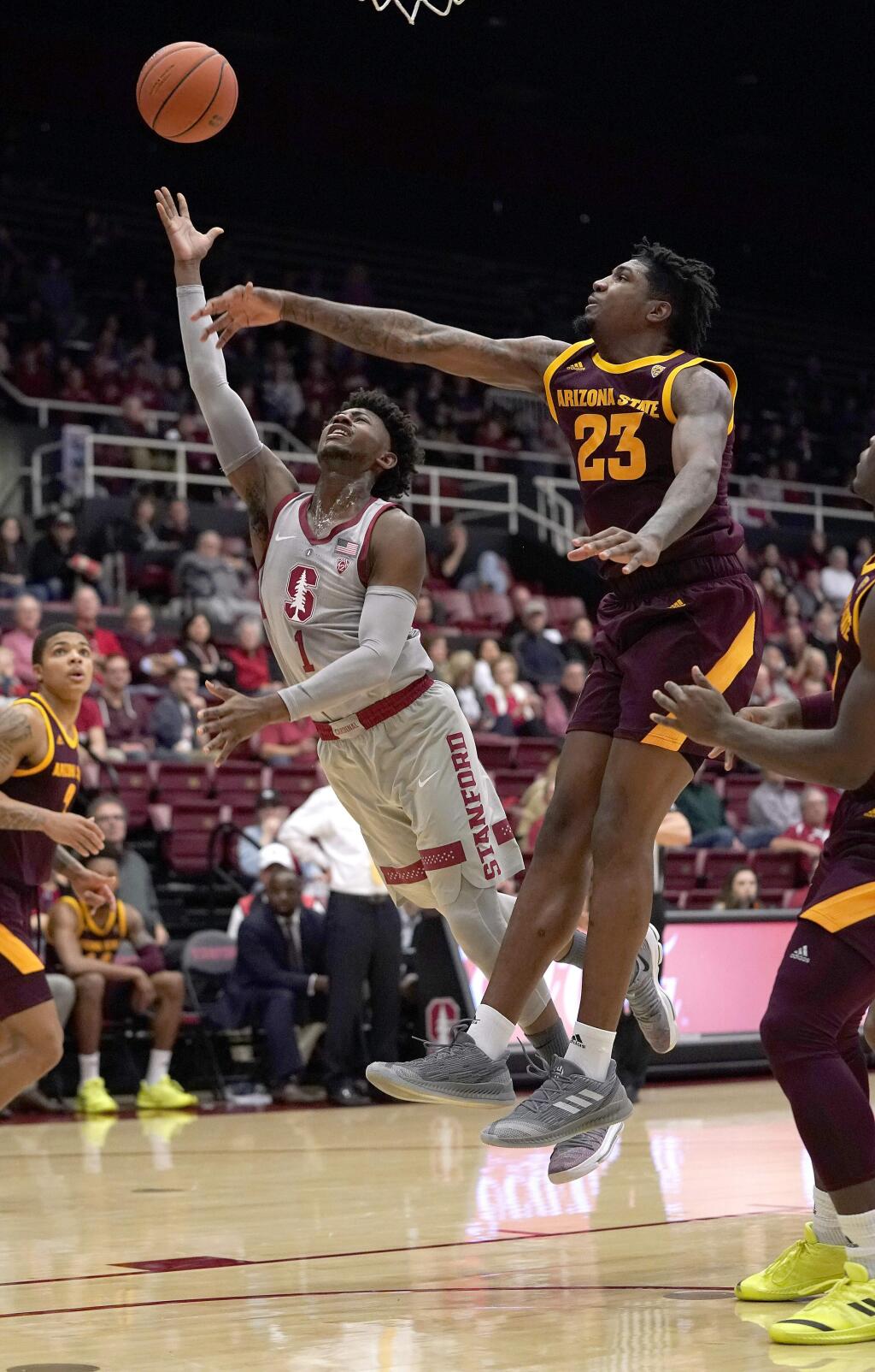 Stanford guard Daejon Davis (1) releases a shot next to Arizona State forward Romello White (23) during the first half of an NCAA college basketball game in Stanford, Calif., Saturday, Jan. 12, 2019. (AP Photo/Tony Avelar)