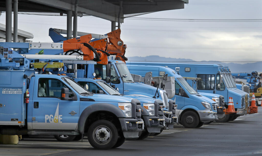 FILE - In this Jan. 14, 2019, file photo, Pacific Gas & Electric vehicles are parked at the PG&E Oakland Service Center in Oakland, Calif. (AP Photo/Ben Margot, File)