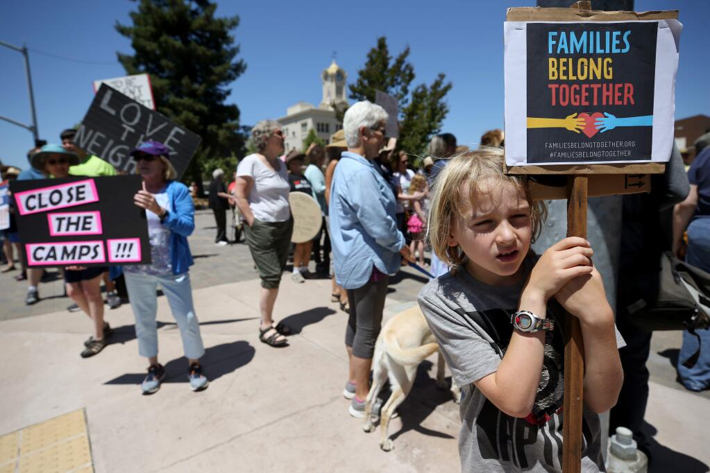 Rio MacDonald, 8, holds a sign opposing the Trump administration's policy of detaining children at the U.S. and Mexico border during a 'Close the Camps' protest at Old Courthouse Square in Santa Rosa on Tuesday, July 2, 2019. The protest was one of many 'Close the Camps' protests being held around the U.S. on Tuesday. (BETH SCHLANKER/ The Press Democrat)