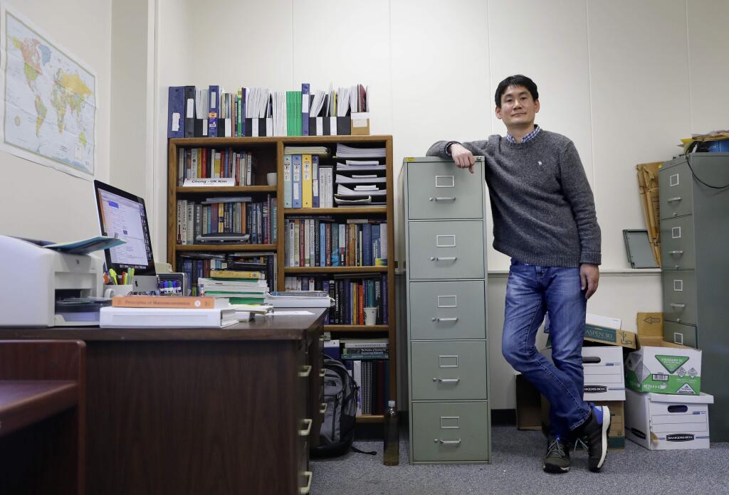 Dr. Chong-Uk Kim, an Associate Professor of Economics, in his office at Sonoma State University campus on Tuesday, February 28, 2017 in Rohnert Park, California . (BETH SCHLANKER/The Press Democrat)