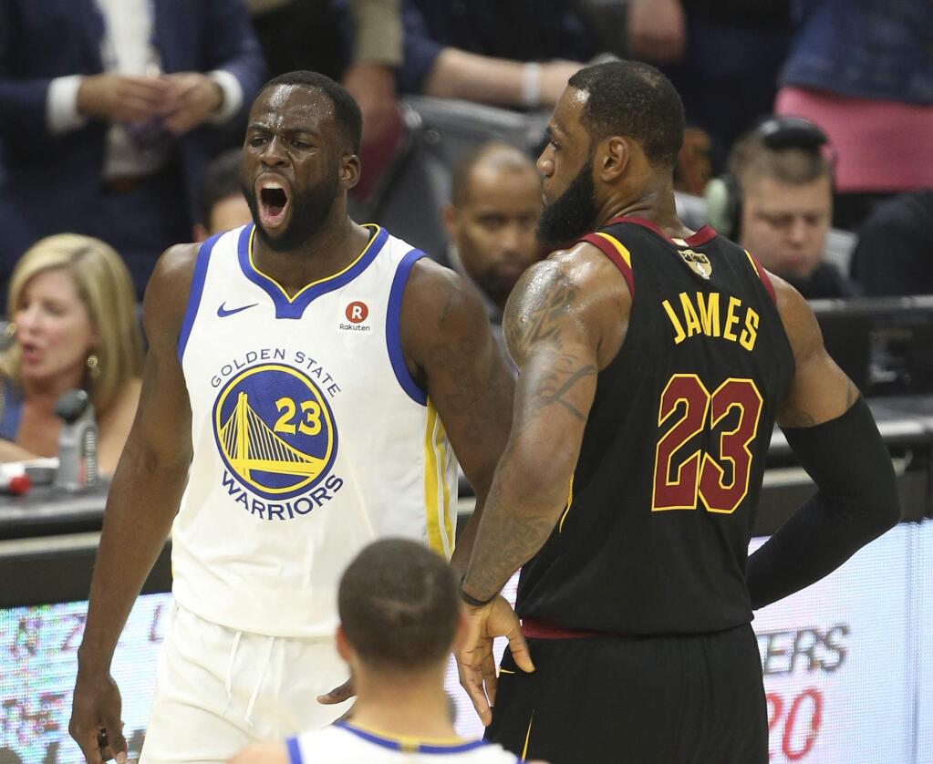 Golden State Warriors forward Draymond Green reacts after getting called for a foul as Cleveland Cavaliers forward LeBron James gives him a bump during the first half of Game 3 of the NBA Finals on Wednesday, June 6, 2018, in Cleveland. (Joshua Gunter/Cleveland.com via AP)