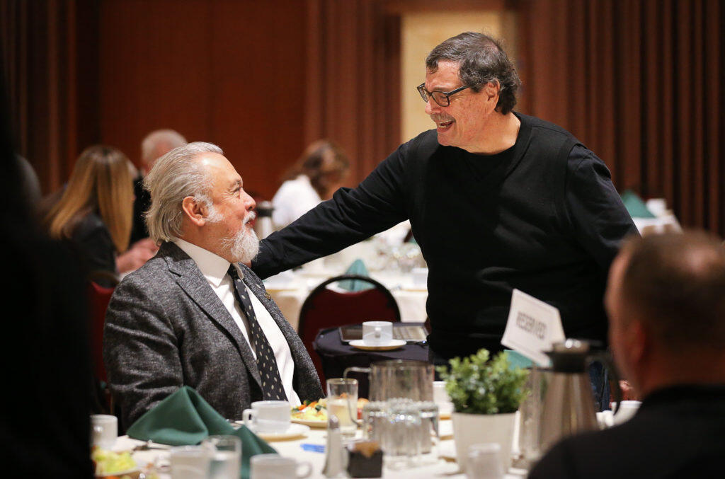 Herman J. Hernandez, right, talks with Carlos Afre, honorary consul of Guatemala, before a Los Cien luncheon in Santa Rosa on Friday, February 15, 2019.   (Christopher Chung/ The Press Democrat)