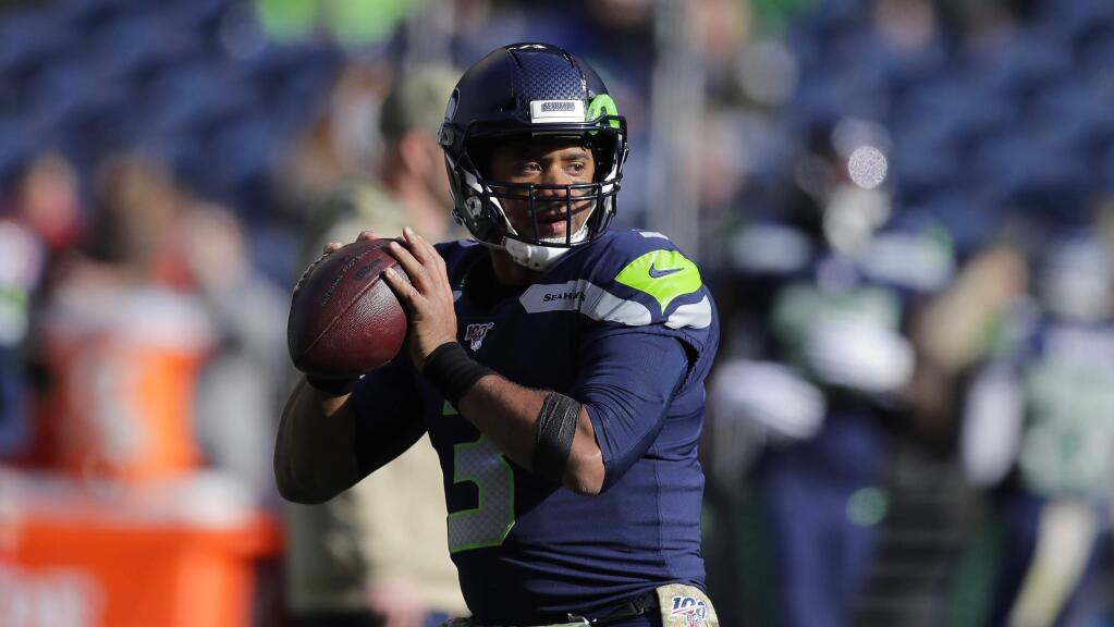 Seattle Seahawks quarterback Russell Wilson passes during warmups before an NFL football game against the Tampa Bay Buccaneers, Sunday, Nov. 3, 2019, in Seattle. (AP Photo/John Froschauer)