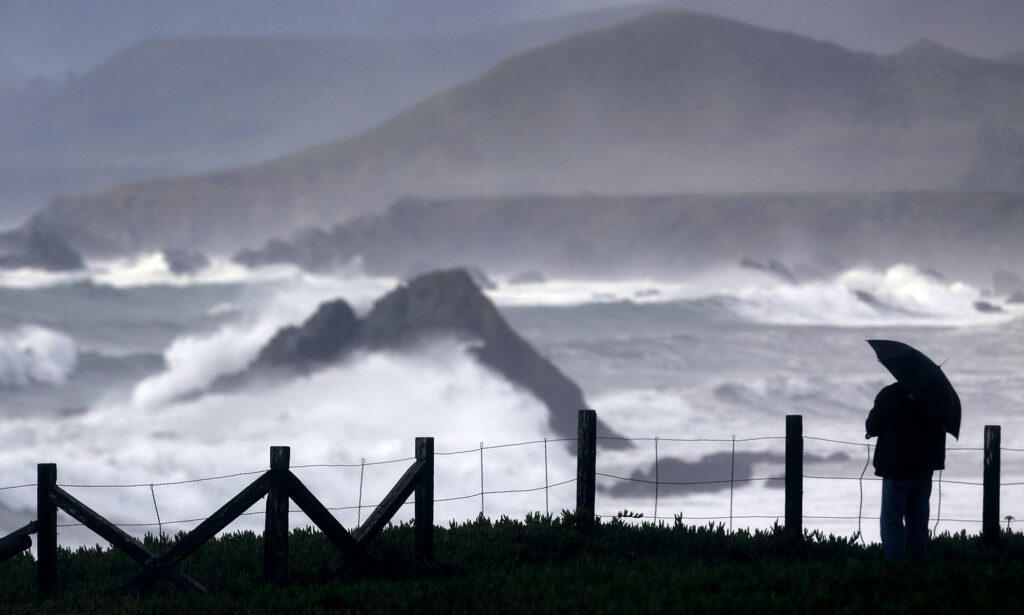 Phillip Knight of San Rafael takes in the very large surf from Duncan’s Landing on the Sonoma Coast, Thursday Jan. 18, 2018 as a pacific storm rolls into Sonoma County.  (Kent Porter / Press Democrat) 2018